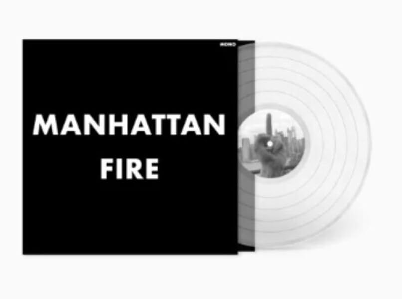 Vinyl record with black cover displaying "Manhattan Fire" in white text.