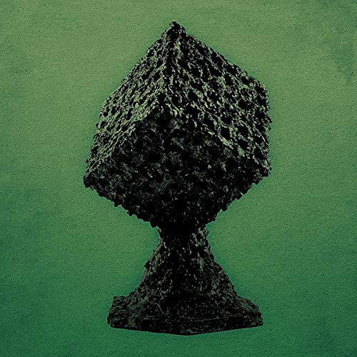 Dark, textured sculpture resembling a chalice against a green background.