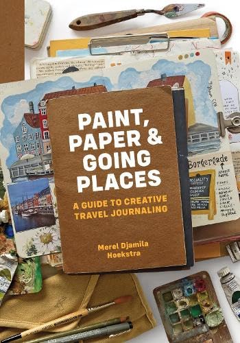 Book cover with art supplies and travel journal pages arranged around it.