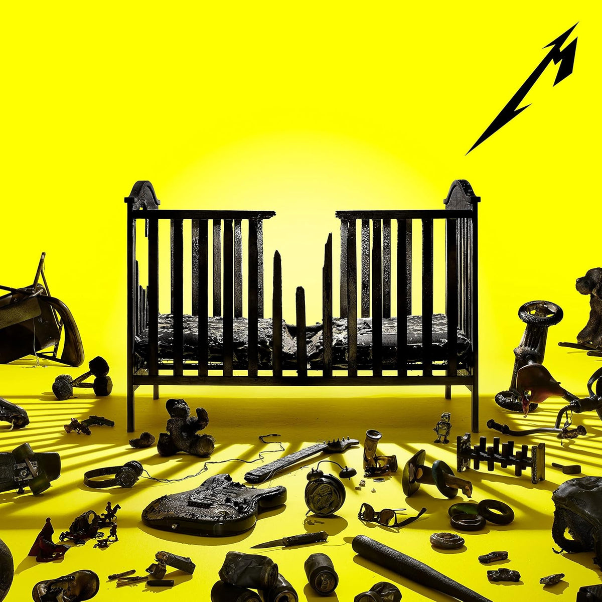 Metallica album cover: black baby crib surrounded by broken objects.