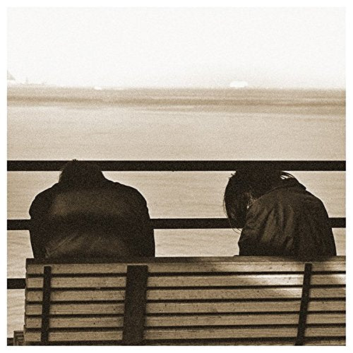 Sepia-toned album cover with two figures looking at a distant seascape.