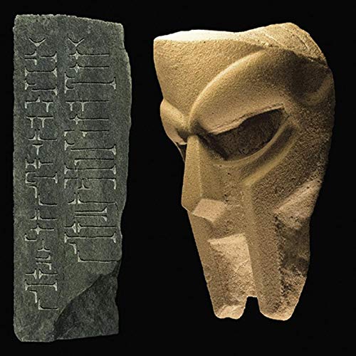 Stone mask and inscribed slab against a black background.