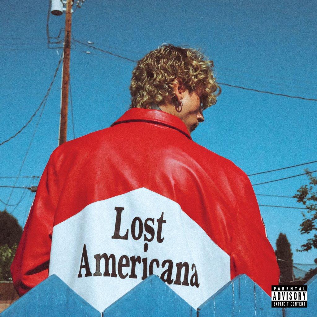 Man with curly hair wearing a red jacket with "Lost Americana" text.