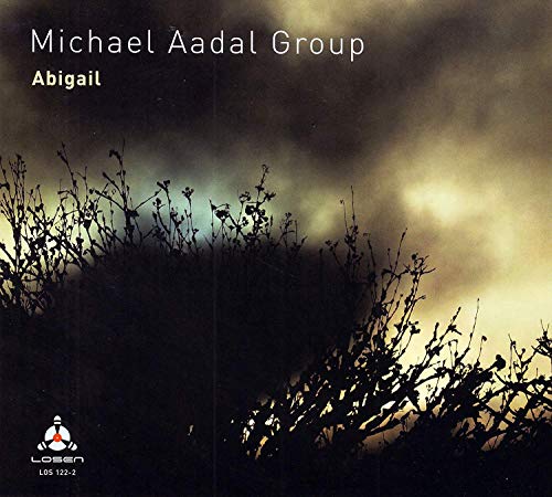 Album cover with dark silhouetted plants against a cloudy, yellow-lit sky.