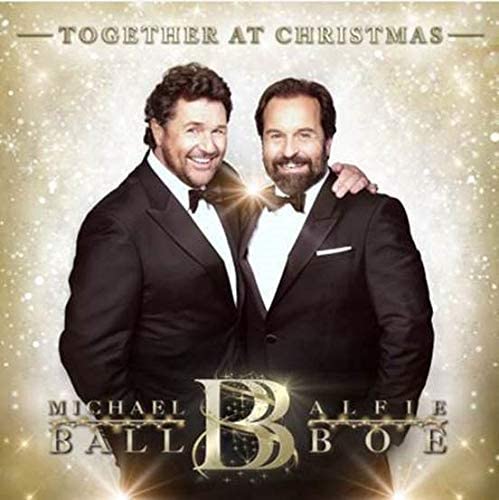 "Album cover featuring two men in tuxedos, with sparkles and gold text."