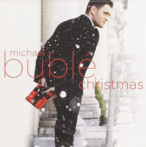 Michael Bublé Christmas album cover, man in suit holding a gift.