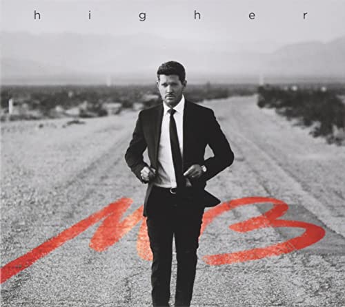 Michael Bublé in suit stands on a desert road with red “MB” logo.