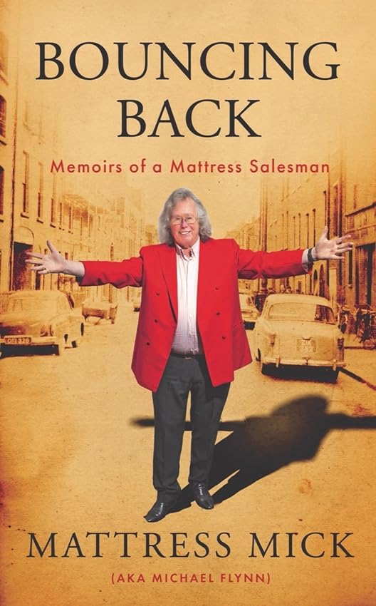 Book cover featuring “Mattress Mick” with arms outstretched on a street.