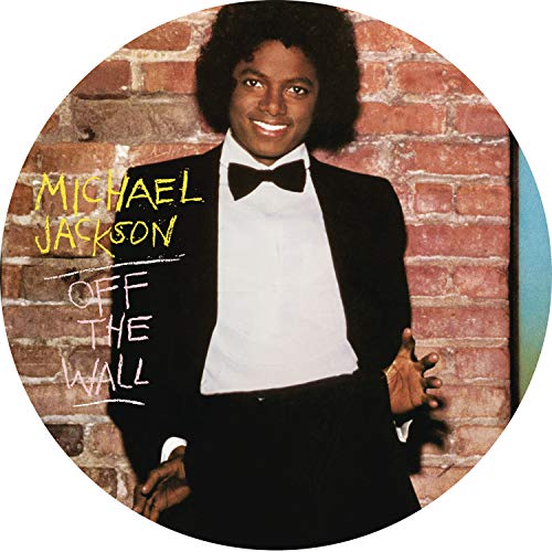Michael Jackson wearing a tuxedo in front of a brick wall on a vinyl disc.