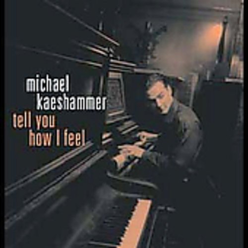 "Album cover with a man playing piano, dark background, and Amazon logo overlay."