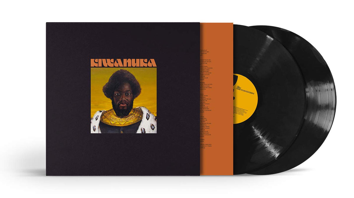 Album cover featuring a man with an afro and ornate clothing against a yellow background.