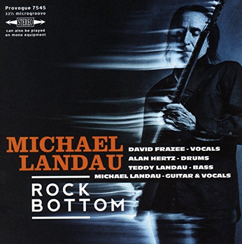 "Album cover with a man holding a guitar, blurred motion effect, dark background."