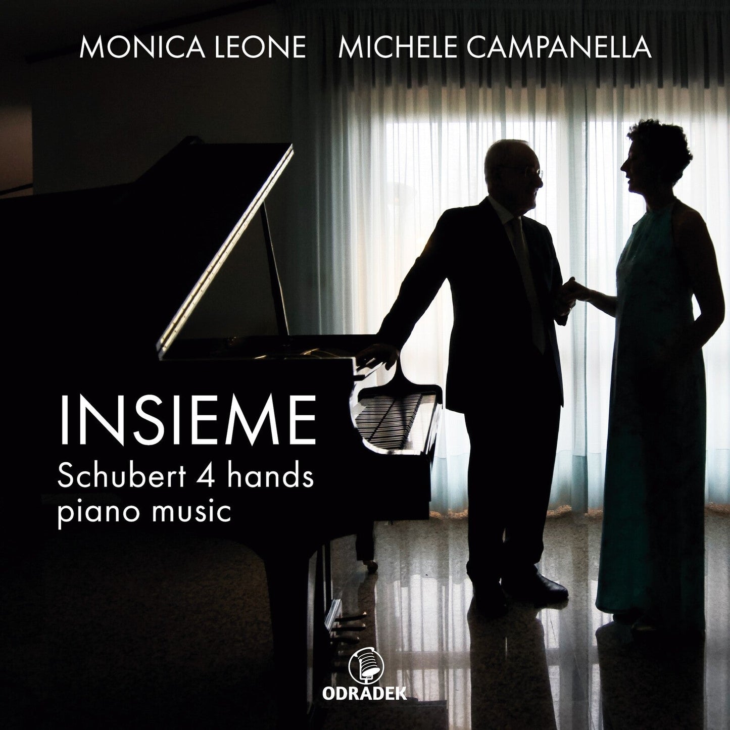 CD cover featuring two pianists standing by a grand piano.