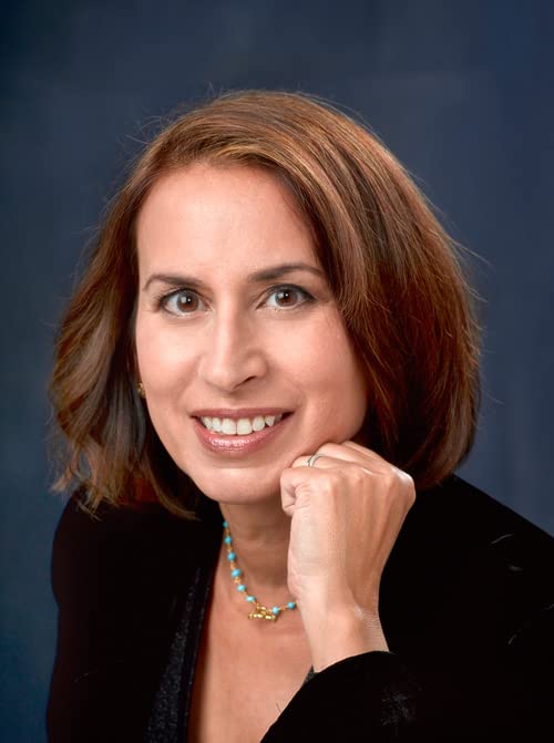 Headshot of author Rachel Slade, smiling, with brown hair and a turquoise necklace.
