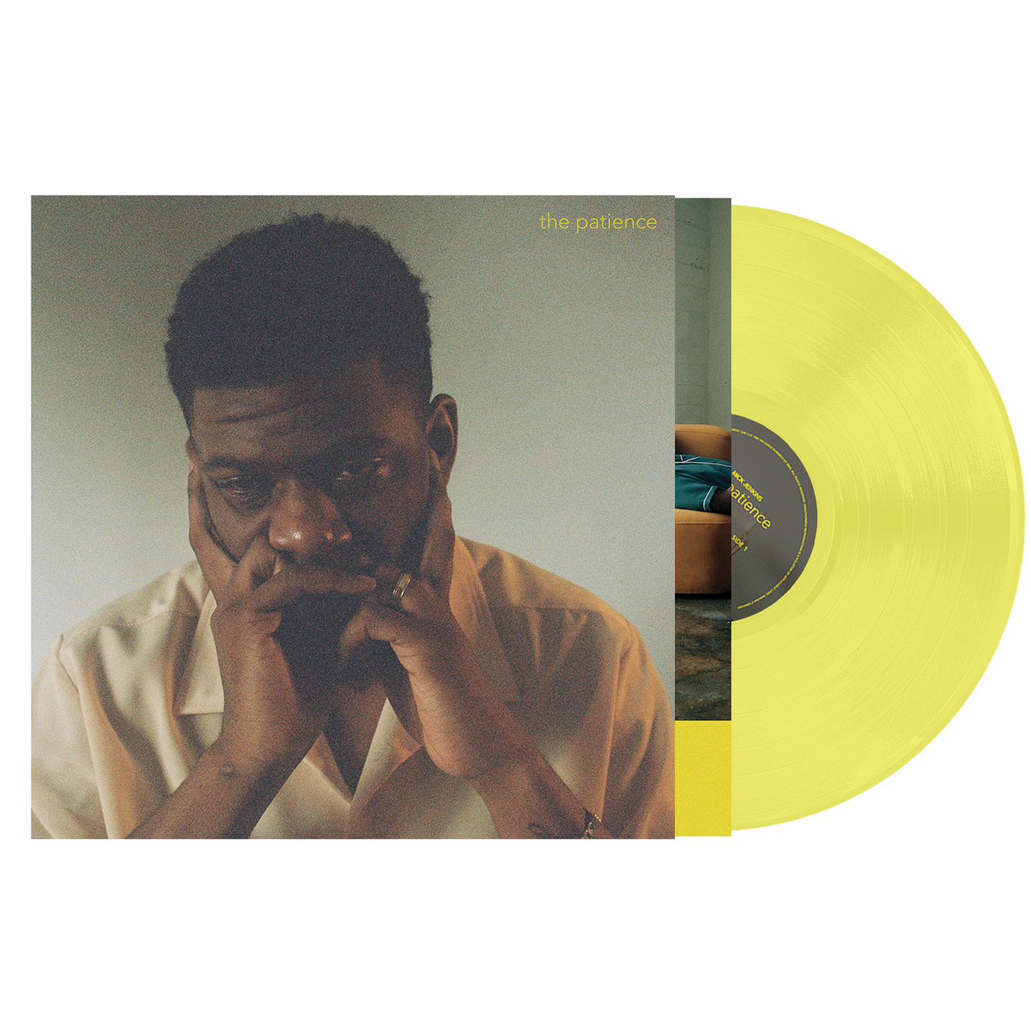 Yellow vinyl record with a cover featuring a man resting his face on his hands.