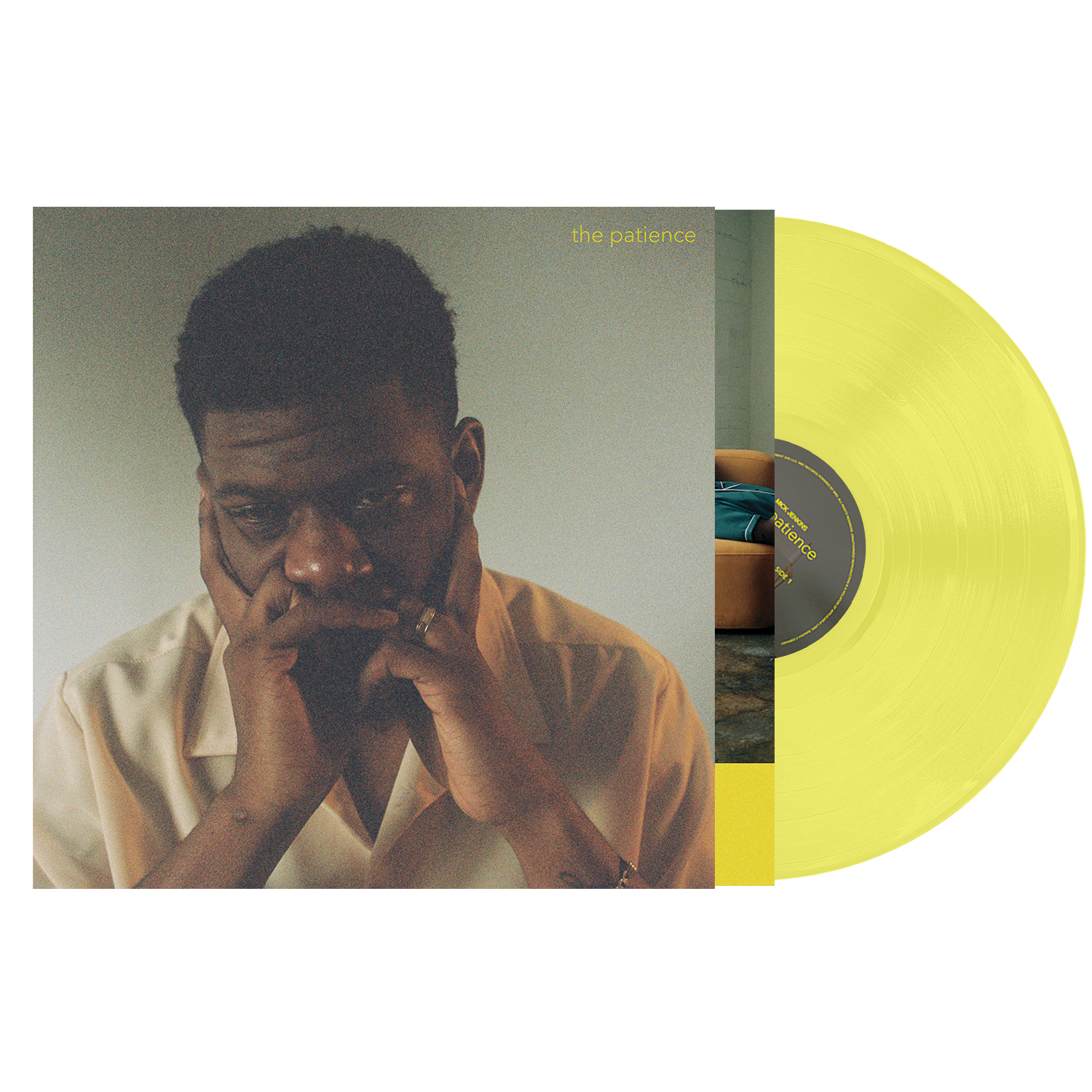 Yellow vinyl record with a cover featuring a man resting his face on his hands.