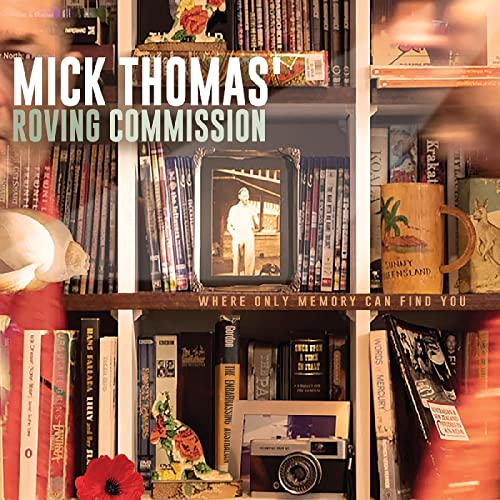 CD cover with books, a framed photo, and decorative objects on shelves.