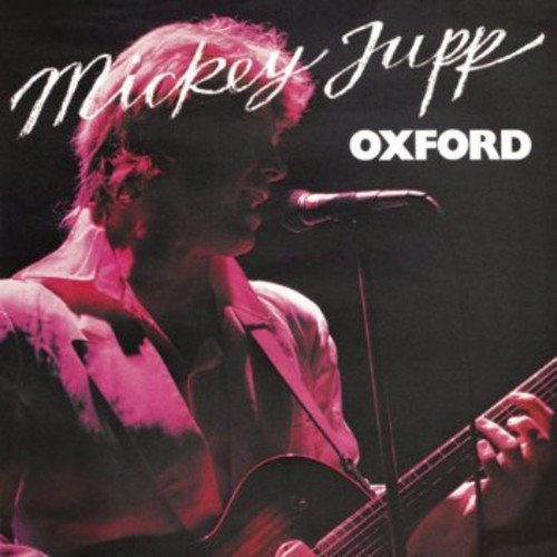 "CD cover featuring Mickey Jupp playing guitar and singing into a microphone."