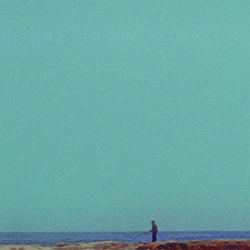 Pale teal album cover featuring a lone figure on a beach.