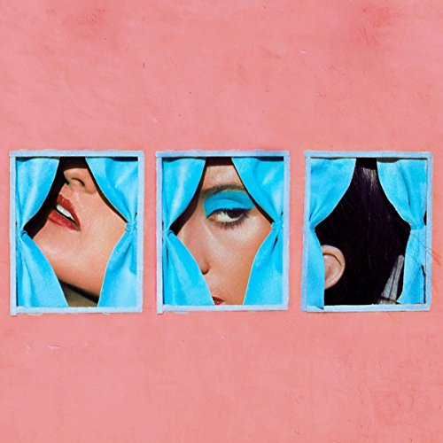 Three framed close-ups of a woman peeking through blue fabric.