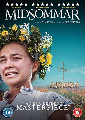 A woman with a flower crown cries in a field with a maypole background.