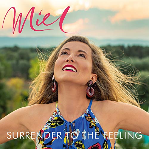 The alt text for the image is: "Album cover with a smiling woman outdoors, wearing a blue floral top."