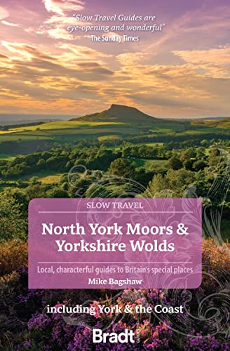 Travel guide cover featuring rolling hills and a prominent peak.