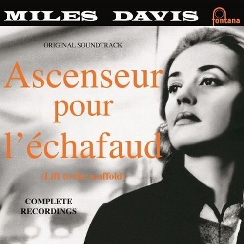 Black and white vinyl album cover featuring a woman looking upwards, with orange and black text.