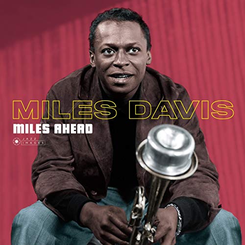 Miles Davis portrait on album cover, holding a trumpet, red background.