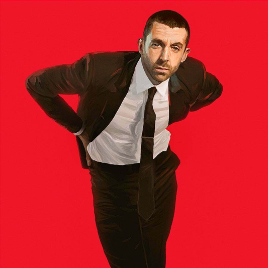 Man in a black suit and white shirt against a red background.