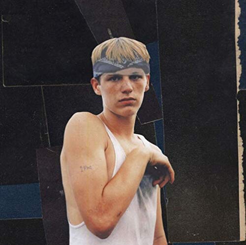 Portrait of Blake Mills with a headband, looking directly at the viewer.