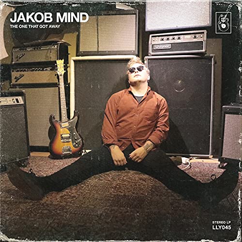 Album cover featuring a musician sitting amongst vintage amplifier stacks.