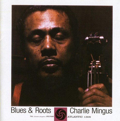 Close-up portrait of Charles Mingus with his double bass, album cover.