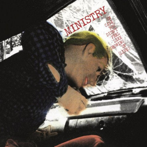 "Vinyl record cover with a man looking into a car's rearview mirror."
