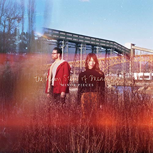 CD cover with two people standing in tall grass before a bridge.