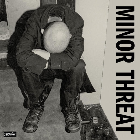 Black and white album cover featuring a person with head in hands.