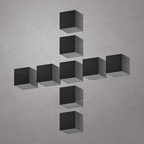 Black cubes arranged in a cross shape on a gray textured background.