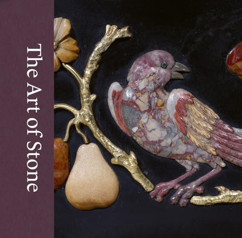 Intricate carved stone sculpture of birds, flowers, and fruit on dark background.