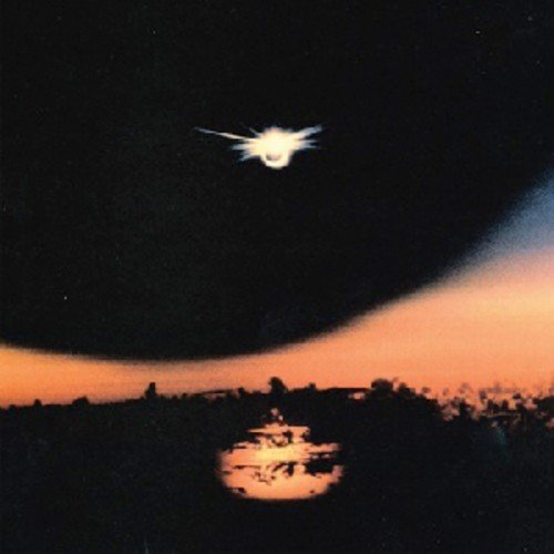 CD cover: Dark sky with a bright, stylized sun and silhouetted landscape.