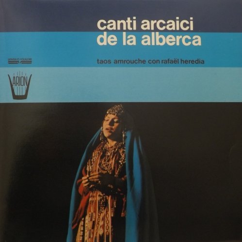 Vinyl record cover: woman in ornate headwear and blue cloak.