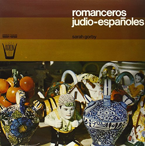 Vinyl record cover with colorful pottery, fruit, and doll figures.