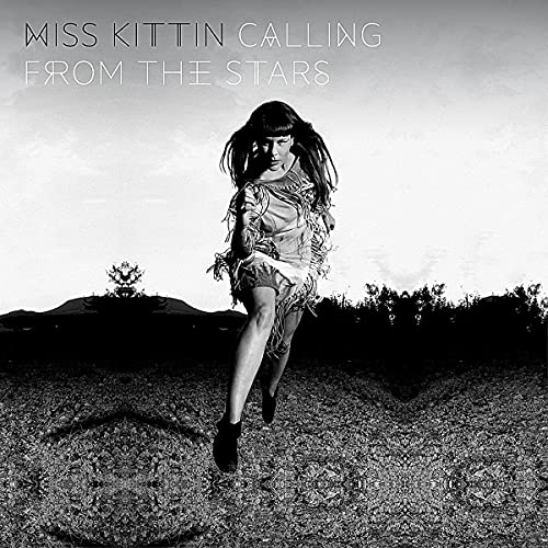 Black and white album cover featuring a woman running in a landscape.
