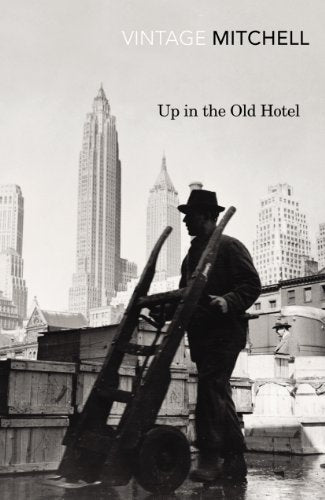 Black and white book cover showing a man pushing a hand truck in New York.
