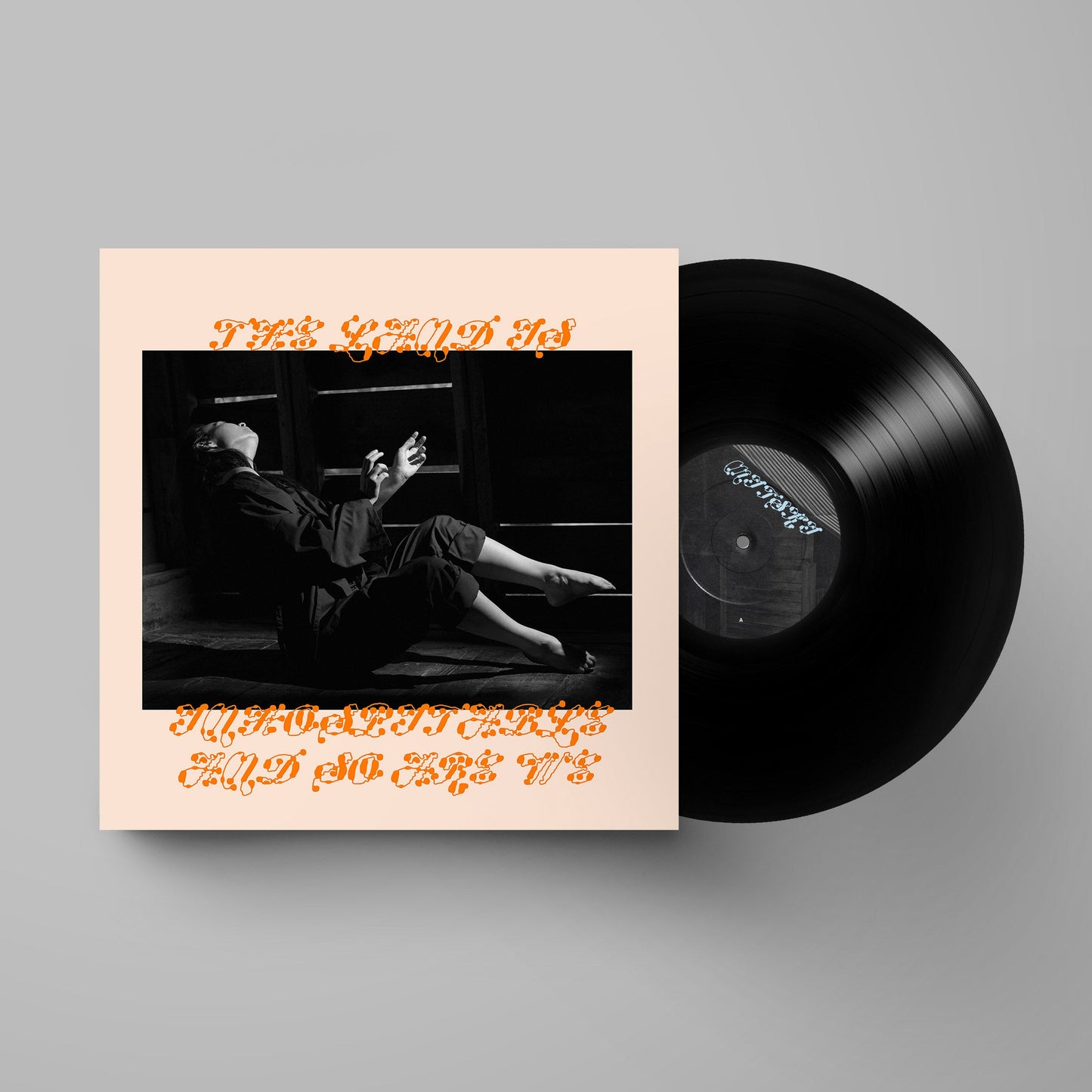 Mitski album cover and vinyl record with a person lying down.