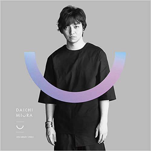 A man in a black shirt stands before a large, gradient U-shaped graphic.