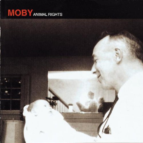 Moby album cover: black and white photo of a man holding a lamb.