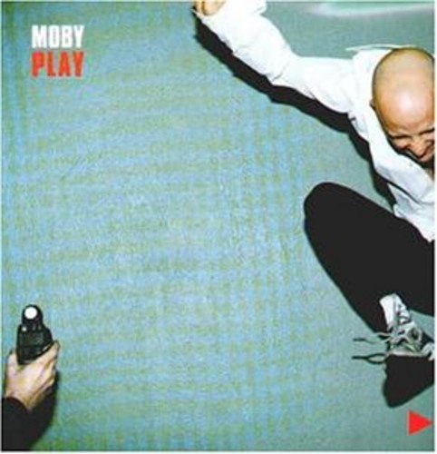 Album cover for Moby’s “Play” featuring a person in motion on blue carpet.