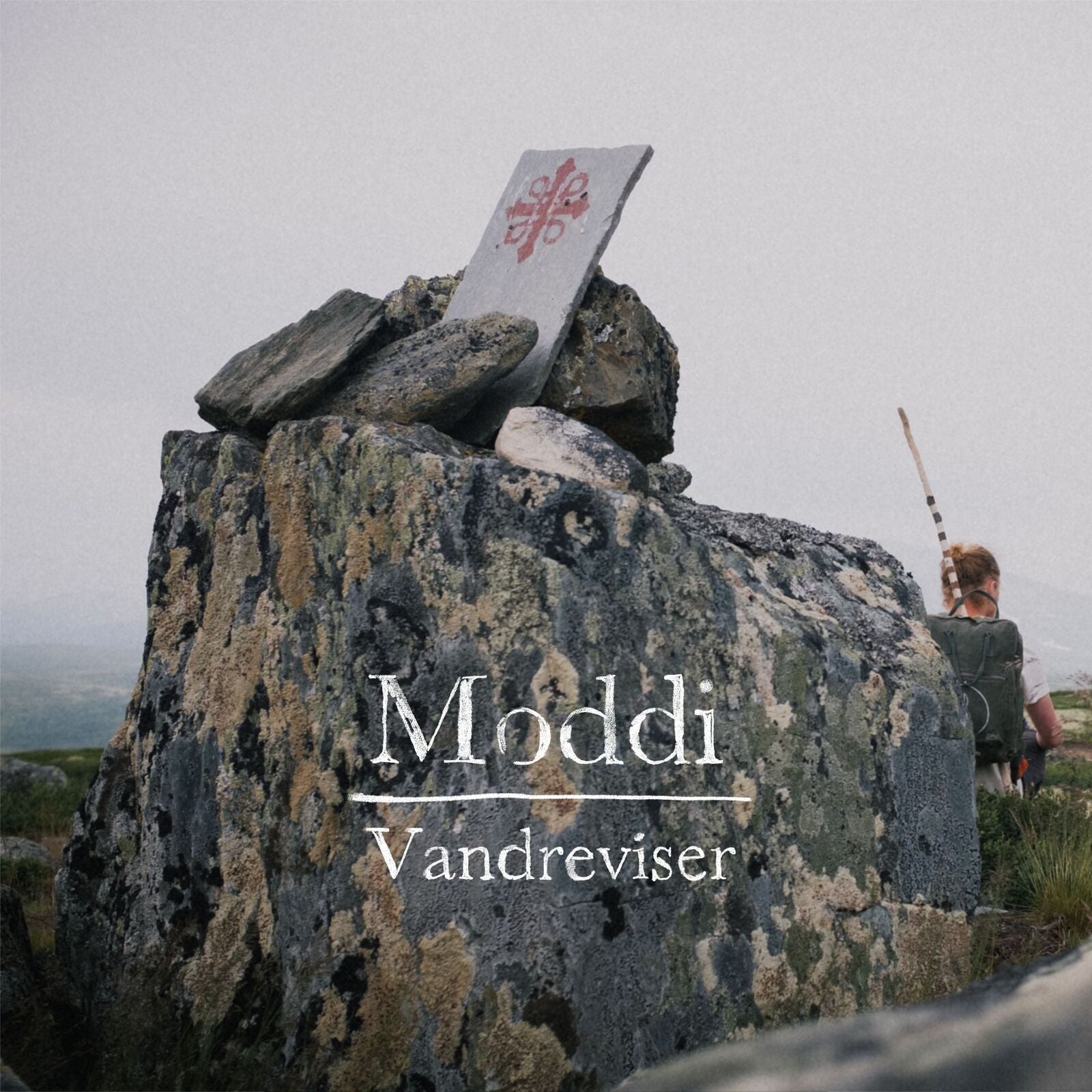 Album cover for Moddi’s “Vandreviser” featuring a rocky landscape.