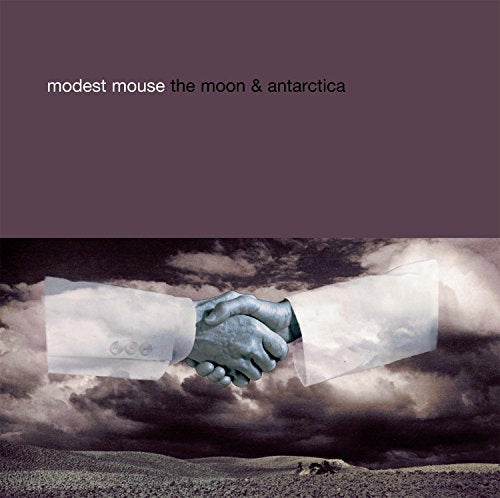 Modest Mouse album cover: hands shaking over a cloudy, barren landscape.