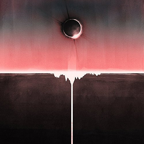 A total solar eclipse hangs above a dark landscape with a vertical light beam.
